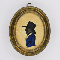 Front of silhouette, in frame, with man looking left, with a hat, wearing blue and yellow jacket.