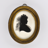 Front of silhouette, in frame, with woman looking right, with ribbon.