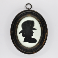 Front of Silhouette, in frame, with woman looking right and wearing a hat