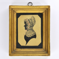 Front of silhouette, in frame, with woman looking left, wearing a bonnet.