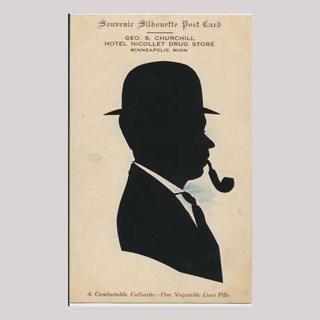 
        Front of silhouette, with man looking right, in suit wearing a hat and smooking a pipe. At the top inscription starting, Souvenir silhouete Post Card...