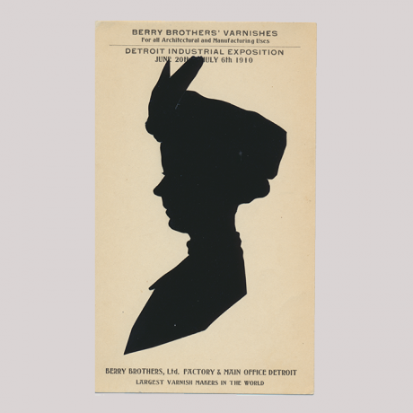 
        Front of silhouette, with woman looking left, wearing a hat. With inscription.