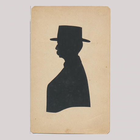 
        Front of silhouette, with man looking left, in suit weraing a hat.