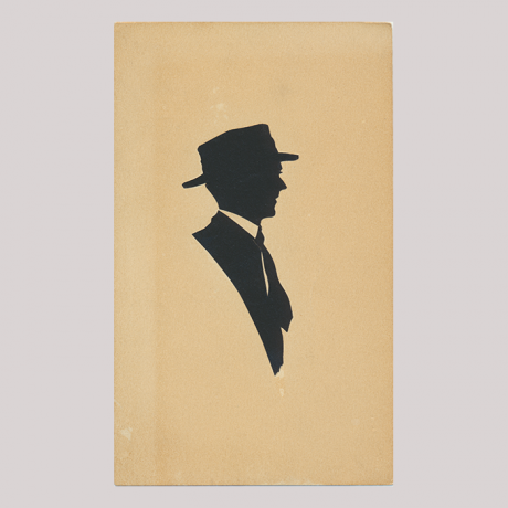 
        Front of silhouette, with man looking right, in suit and wearing a hat.