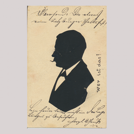 
        Front of silhouette, with man looking right, in suit. Some inscriptions are hand-written in german.