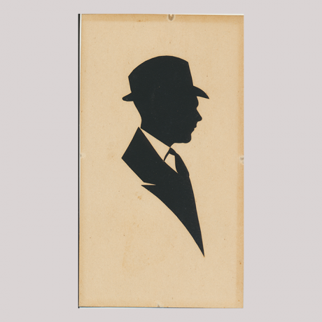 
        Front of silhouette, with man looking right, in suit and wearing a hat.