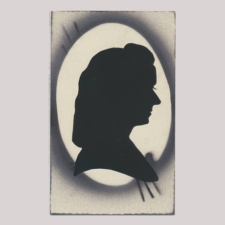 
        Front of silhouette, with woman looking right in oval frame.